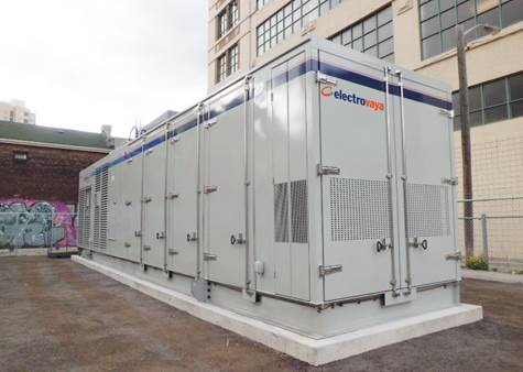 Large battery storage unit adjacent to a multi-level building