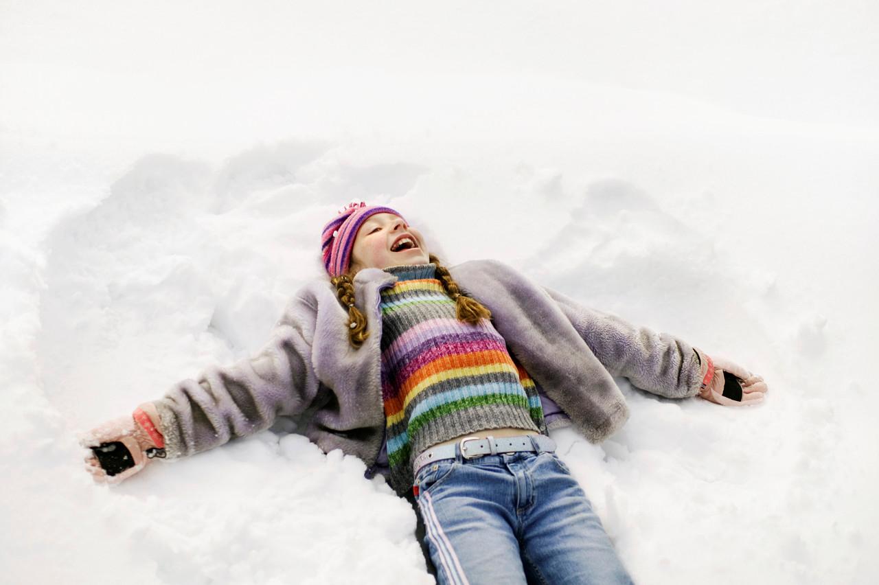 Child making a snow angel