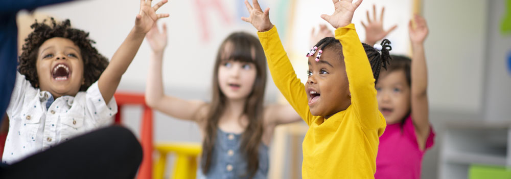 Group of children holding hands up