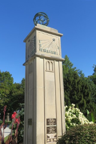 Tall granite plinth with an bronze astrolabium and sundial.