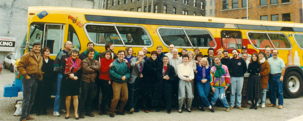 English and French radio staff in front of the CBE 1550 promotional bus, circa 1993. 