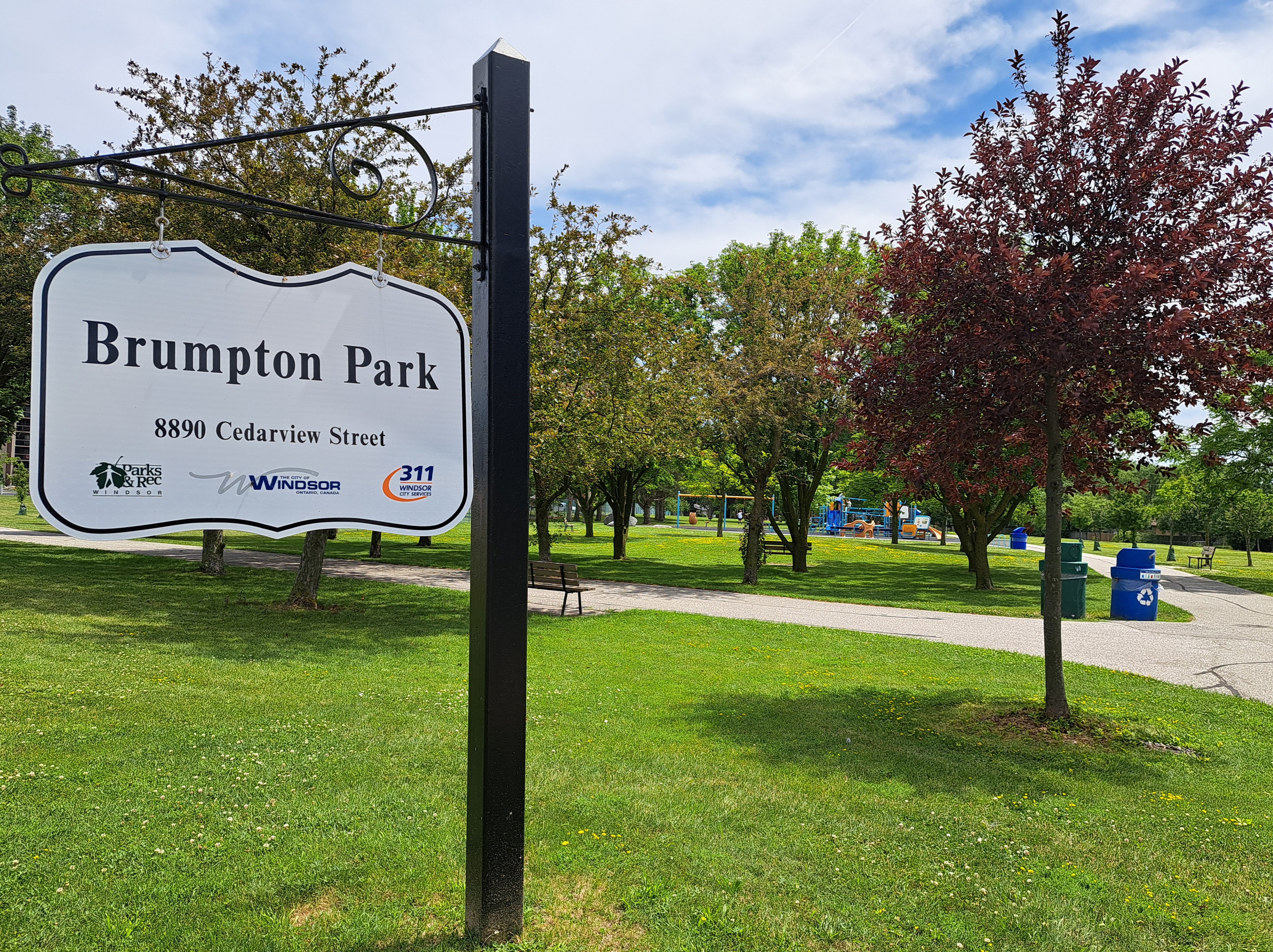 Brumpton Park sign and trees on green grass