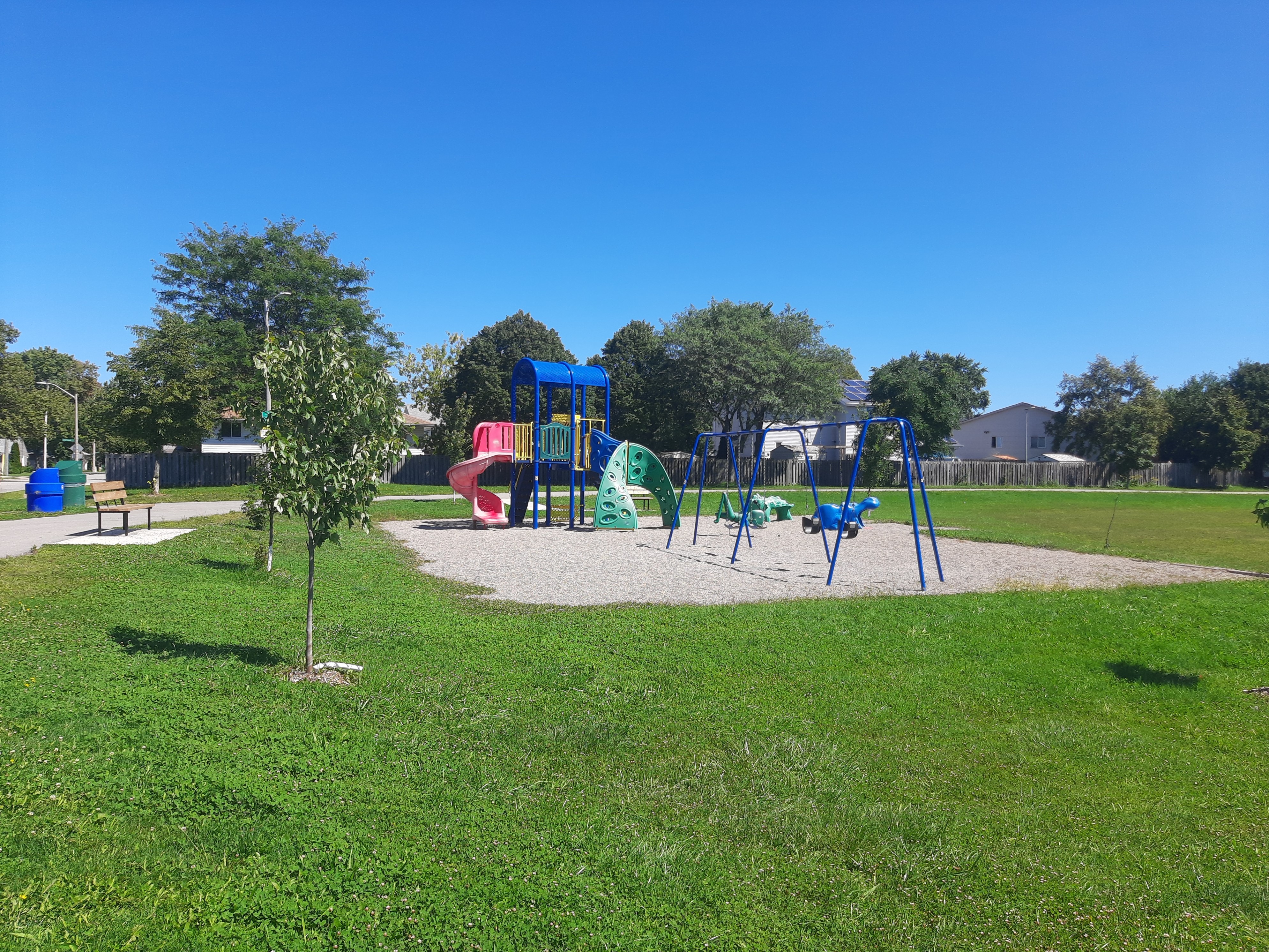 Playground and swing set on green grass