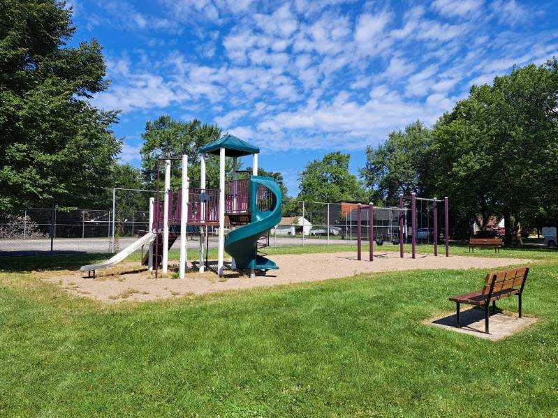 Playground with bench and tennis courts