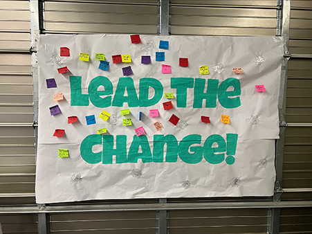 A mural that says Lead the Change!
