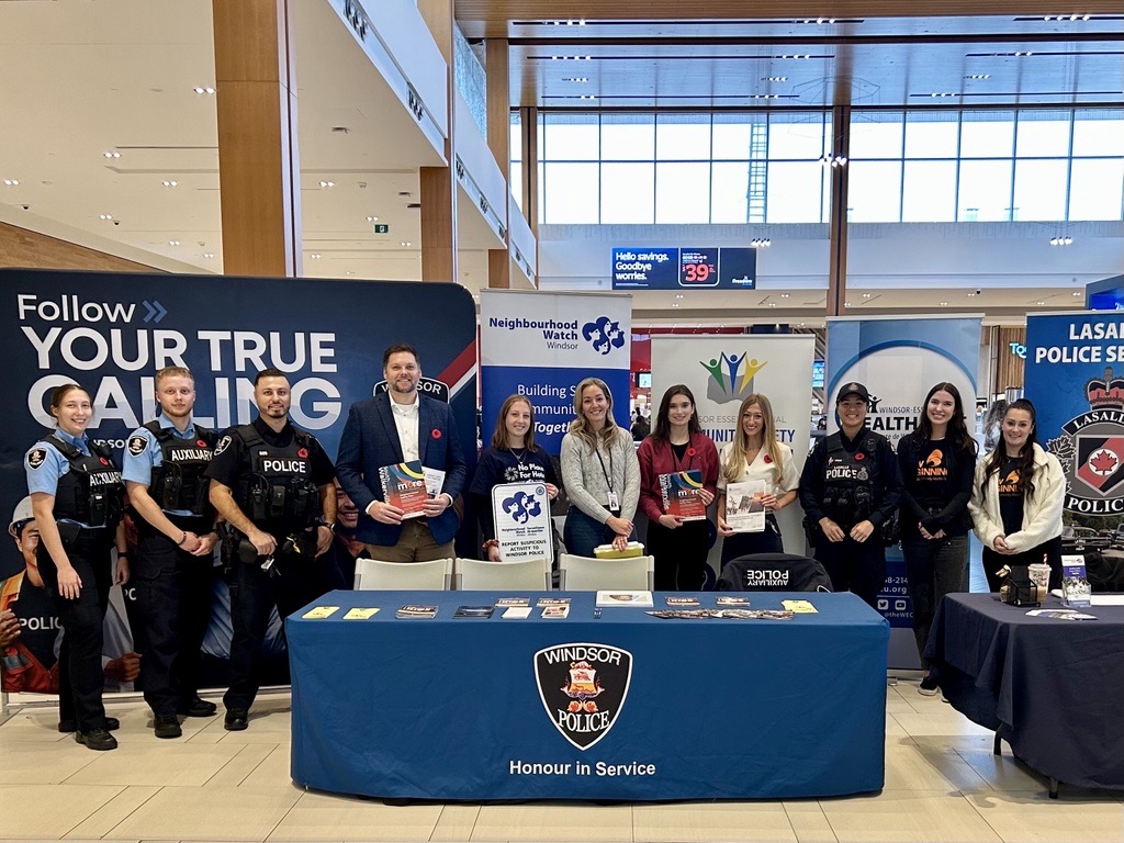 Police officers and service providers gathered around the Windsor Police Service booth at Devonshire Mall for Crime Prevention Week