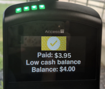 Umo yellow checkmark on a screen with indication of fare paid and low cash balance remaining